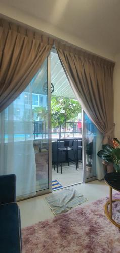 a living room with a large sliding glass door at Ayesha Metrocity Staycation N-02 & N-5-03 in Kuching