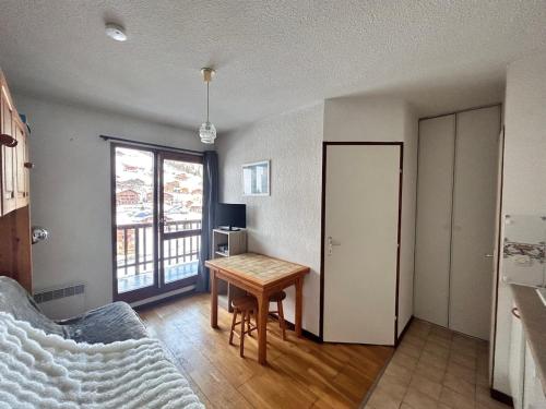 a living room with a table and a window at Appartement Arêches in Beaufort