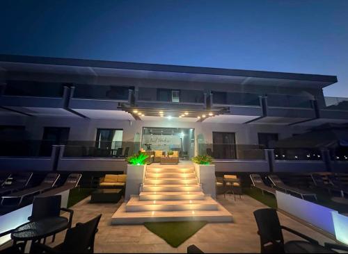 a view of a building with a patio at night at BEST PARADISE IN NIKITI in Nikiti
