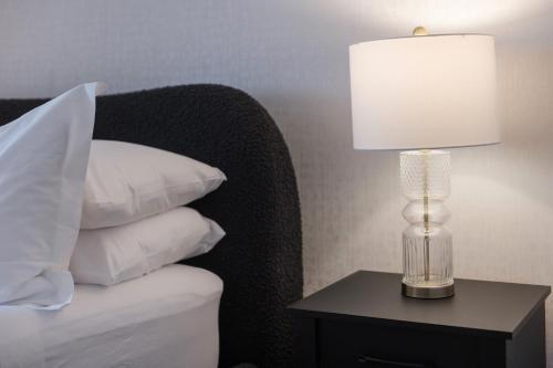 a lamp on a table next to a bed with pillows at Doctor Sax House in Lenox