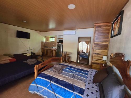 a bedroom with a bed and a living room at Cool Waters Jungle Villas in Uvita