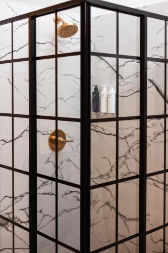 a room with a glass wall with a shelf at Doctor Sax House in Lenox