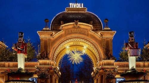 an entrance to a building with a christmas tree at Best Location - 5 Min To Tivoli And Main Station in Copenhagen
