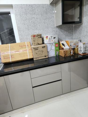 a kitchen counter with boxes on top of it at Modern New 2 BHK Studios in Kondapur Near Gachibowli in Hyderabad