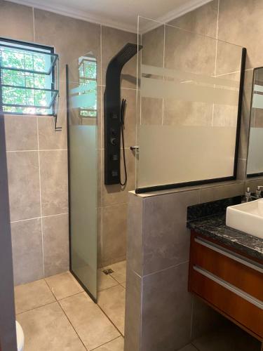 a shower with a glass door in a bathroom at Chalet Fratelli Rigoni in Villa Ciudad Parque