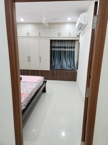 a room with a bed and a window at Modern New 2 BHK Studios in Kondapur Near Gachibowli in Hyderabad