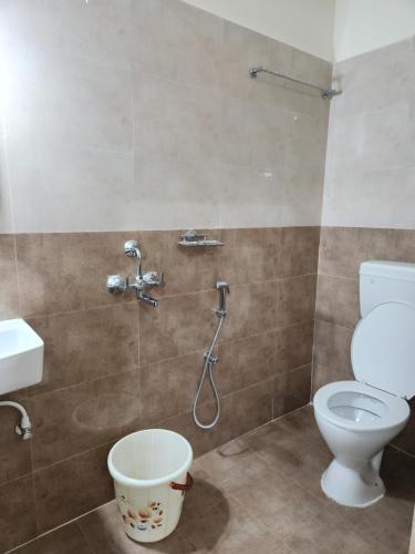 a bathroom with a toilet and a shower at Modern New 2 BHK Studios in Kondapur Near Gachibowli in Hyderabad