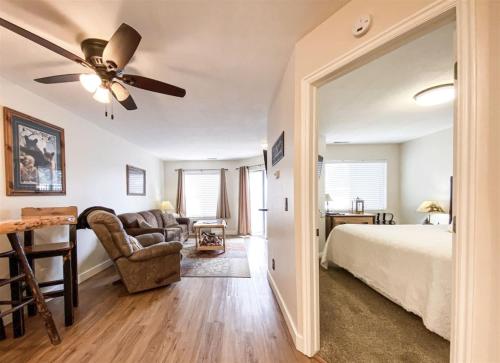 a bedroom with a bed and a ceiling fan at Inn Building Condo 113, Ground Level, Pool Side in Garden City