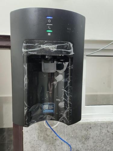 a black espresso machine sitting on top of a counter at Modern New 2 BHK Studios in Kondapur Near Gachibowli in Hyderabad