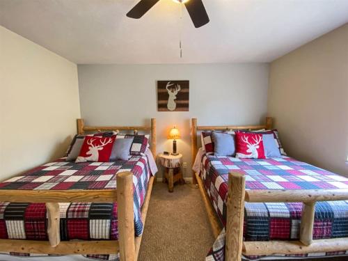 a bedroom with two beds and a ceiling fan at Lake View Condo 930 2 in Garden City