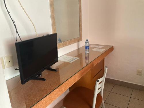 a television sitting on a desk in a room at Hotel Camba in Oaxaca City