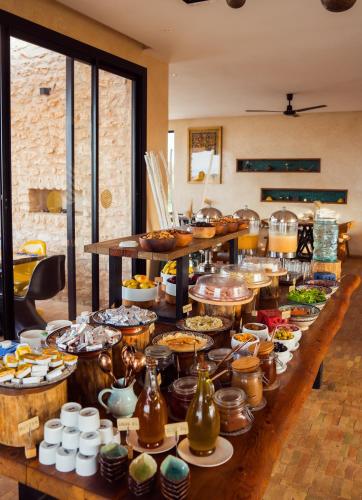 a long table filled with pots and pans of food at BABERRIH Hôtel Hospitality Palaces & Resorts in Essaouira