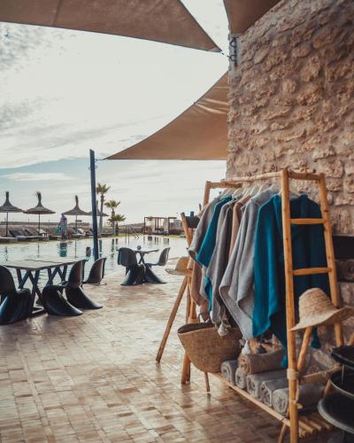 a rack of shoes sitting next to a pool at BABERRIH Hôtel Hospitality Palaces & Resorts in Essaouira