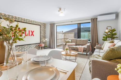 a living room with a couch and a table at Pool-Table, Projector, Fooseball -By KOSH BNB in Hamilton