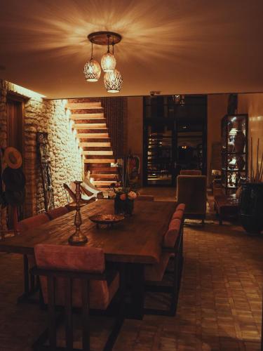 a dining room with a table and a staircase at BABERRIH Hôtel Hospitality Palaces & Resorts in Essaouira
