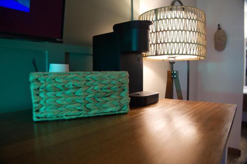 a table with a lamp and a light on it at Jonesbones Room at White Wing Lodge- Silver Dollar City Getaway in Branson