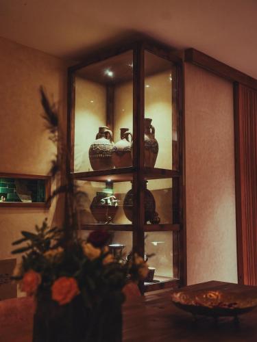 a glass cabinet with vases in it at BABERRIH Hôtel Hospitality Palaces & Resorts in Essaouira