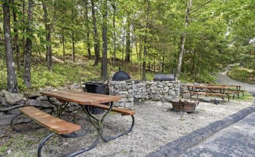 a group of picnic tables and a stone wall at Jonesbones Room at White Wing Lodge- Silver Dollar City Getaway in Branson