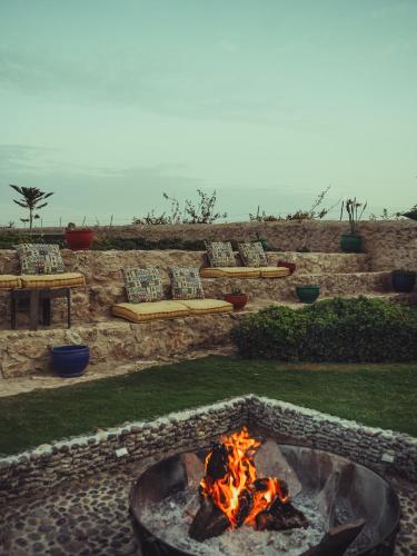 a fire pit in the middle of a yard at BABERRIH Hôtel Hospitality Palaces & Resorts in Essaouira