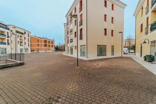 an empty street in a city with buildings at cIVico Quattro in Montecchio Maggiore