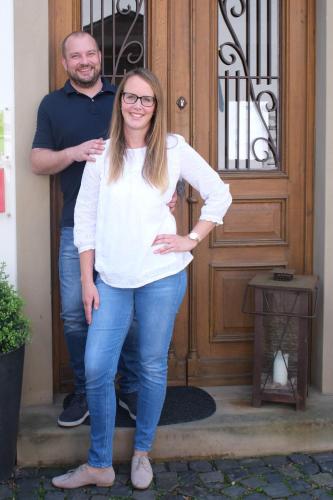 a man and a woman standing in front of a door at Cabinett 1876 in Trittenheim