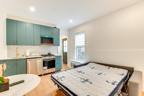 a kitchen with a large bed in a room at Centrally Located and Pet Friendly Yonkers Studio! in Yonkers