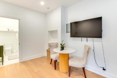 a dining room with a table and chairs and a tv at Centrally Located and Pet Friendly Yonkers Studio! in Yonkers