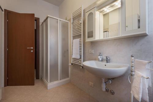 a bathroom with a sink and a shower at San Macario House MXP Airport in Samarate