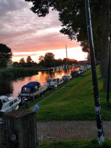 a group of boats parked in a marina at sunset at In het mooie Friesland Vele bezienswaardigheden in Hantum