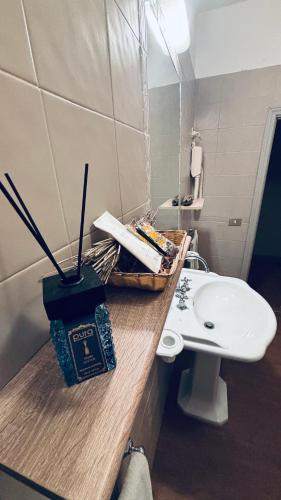 a bathroom with a counter with a sink and a toilet at Terracqua & Locanda Granducato in Chiusi