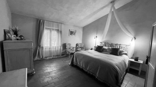 a bedroom with a bed and a dresser and a window at Terracqua & Locanda Granducato in Chiusi