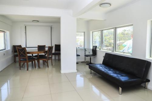 a living room with a couch and a table and chairs at Vitrali Suite in Copiapó