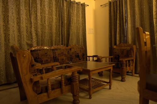 a dining room with a wooden table and chairs at Himalayan Manor in Dehradun