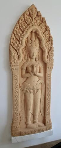 a statue of a woman sitting in a chair at Jasmine Village in Rawai Beach