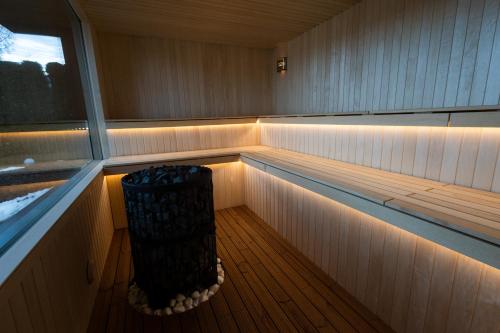 a sauna with a bench in the middle of it at Hotel Roser House Boutique - pe malul lacului Colibita in Colibiţa