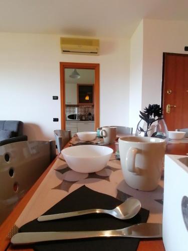 a table with bowls and spoons on top of it at hopefco in Fiumicino