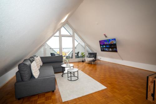 a living room with a couch and a tv at Feel like Home 4 in Biberach an der Riß