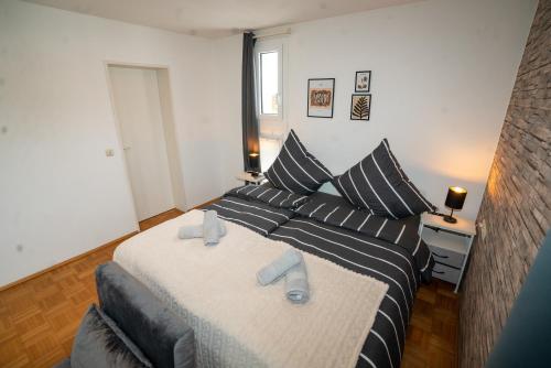 a bedroom with a large bed with two pillows at Feel like Home 4 in Biberach an der Riß