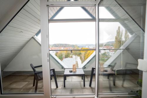 a room with a table and a large window at Feel like Home 4 in Biberach an der Riß
