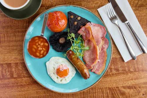 a blue plate with breakfast food on a table at Hotel Victoria in Whitby