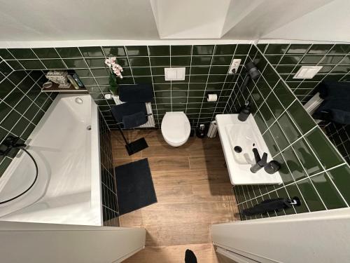 a bathroom with a white sink and a toilet at Ferienwohnung Gütersloh in Gütersloh