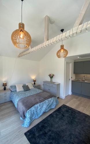 a bedroom with a bed and two lights at The Garden Room in Henley on Thames