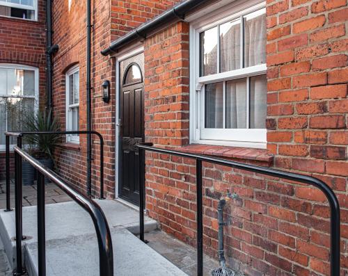 a brick building with a black door and a window at Hotel Victoria in Whitby