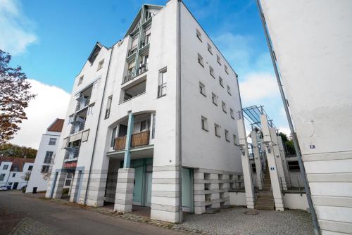 a white building with its reflection in a mirror at Feel like Home 4 in Biberach an der Riß