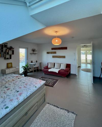 a bedroom with a bed and a living room at La Dolce Vita Apartment in Kehl am Rhein