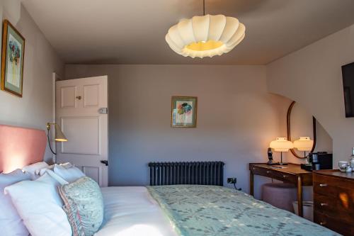 a bedroom with a bed and a chandelier at Hotel Victoria in Whitby