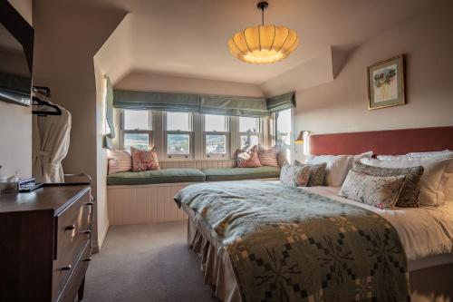 a bedroom with a large bed and a window seat at Hotel Victoria in Whitby