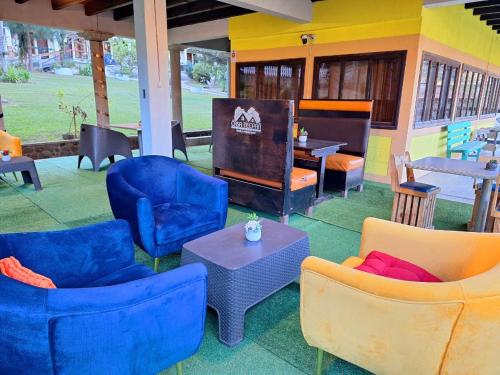 a group of chairs and tables in a patio at Hotel Casa Tecpán in Pamanzana