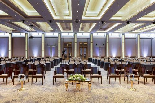 a large room with rows of tables and chairs at Signia by Hilton in Amman