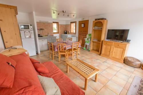 un salon avec un canapé et une table et une cuisine dans l'établissement Appartement 7 personnes, Samoëns, à Samoëns